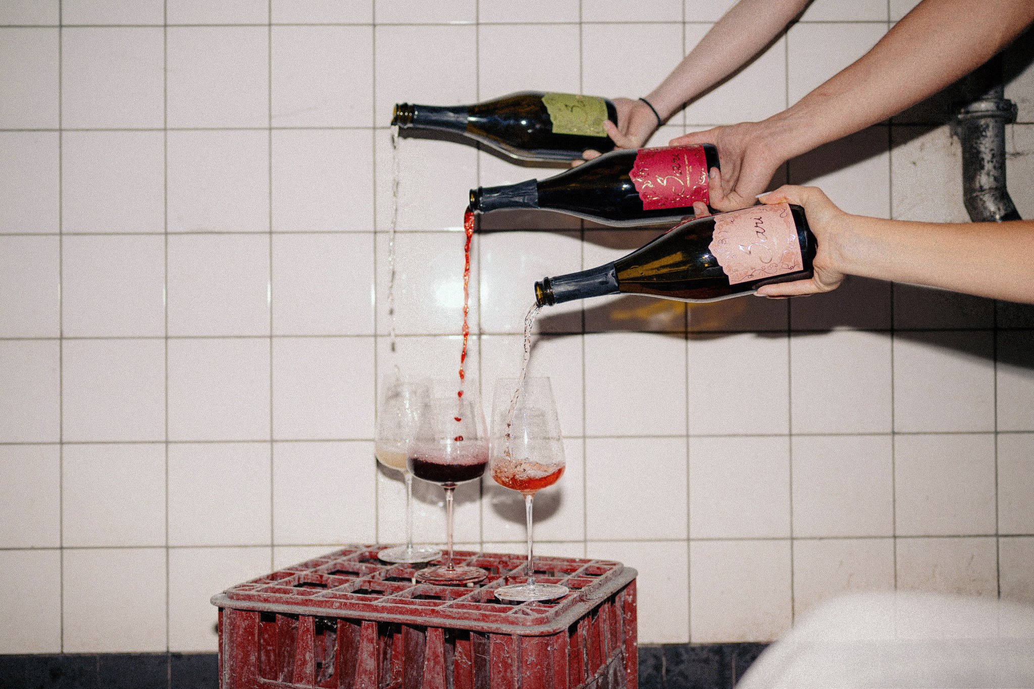 Sari Red being poured into a wine glass at a table
